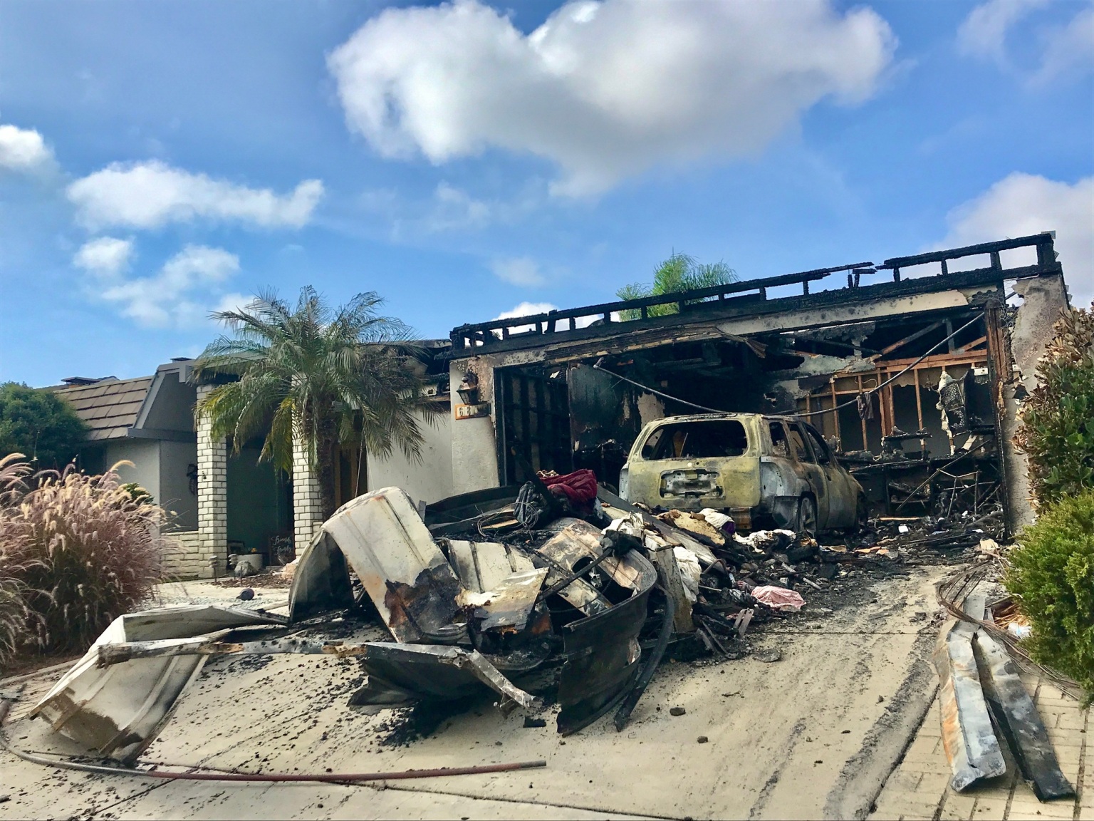 House fire caused this garage to be burned along with the car inside. Insurance is necessary.