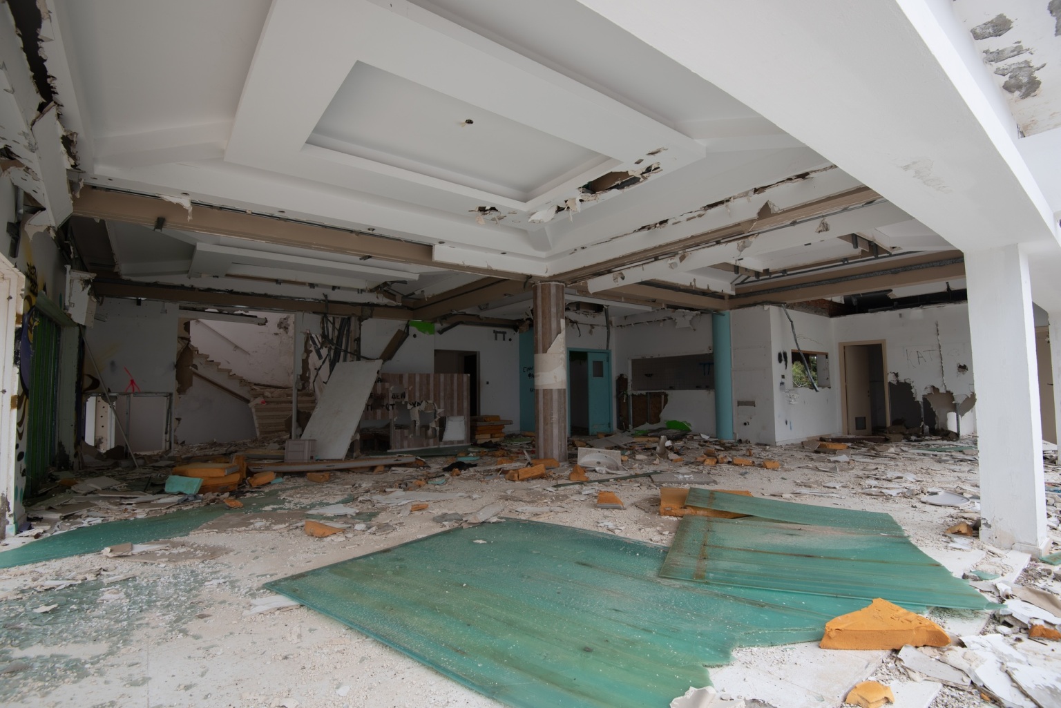 Interior of an old abandoned room with damaged furniture and a messy floor