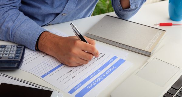 Man preparing an Insurance Claim Form